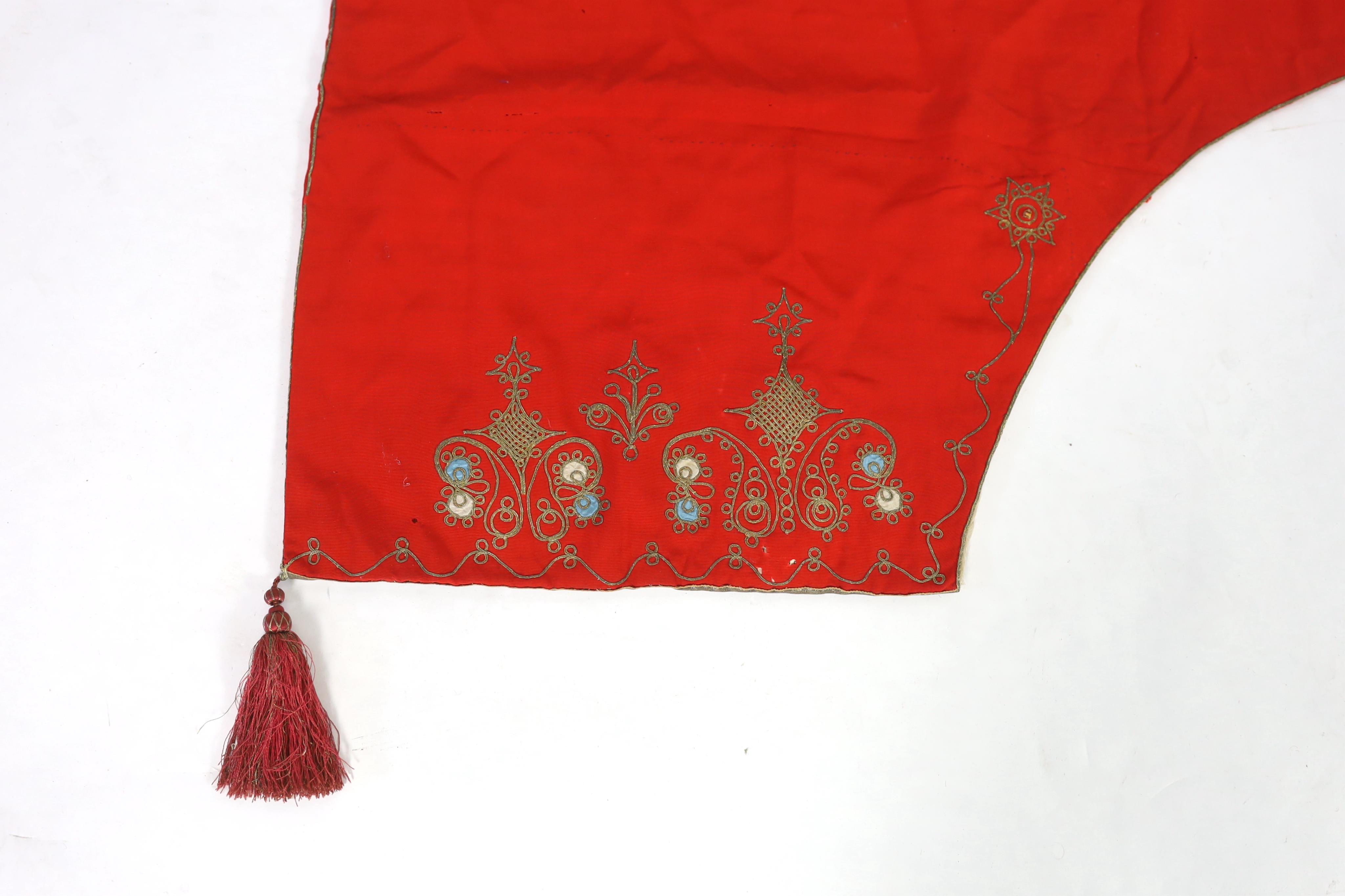 A pair of 1970's Iranian ‘Geevay’ slippers, the soles made from tyres and tops hand crochet together with a 19th century fine red wool hood with gold embroidery and a red tassel, possibly Spanish, ecclesiastical hood